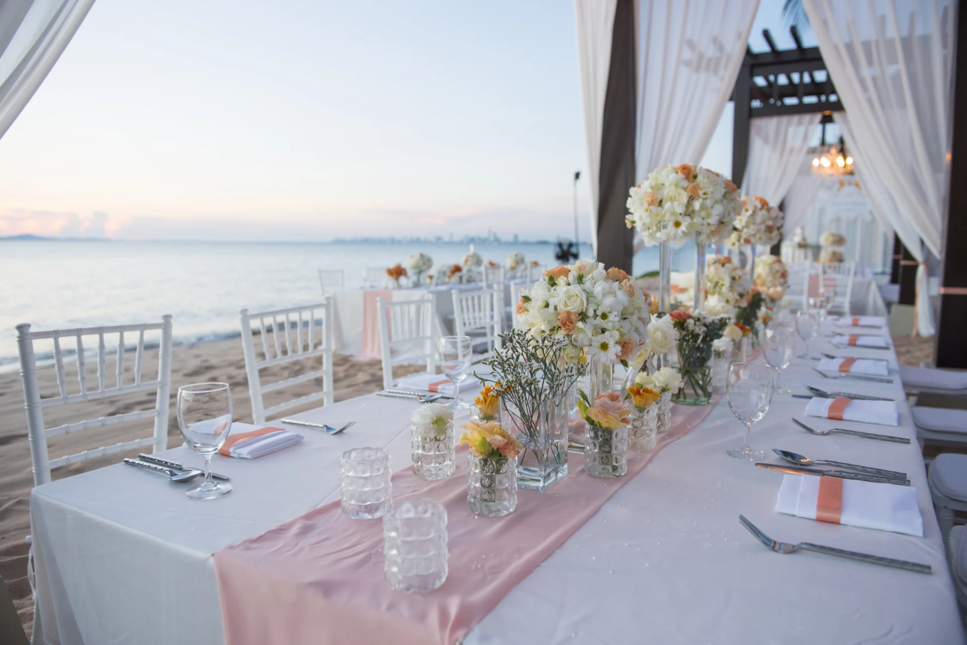 A table set up with flowers and candles.