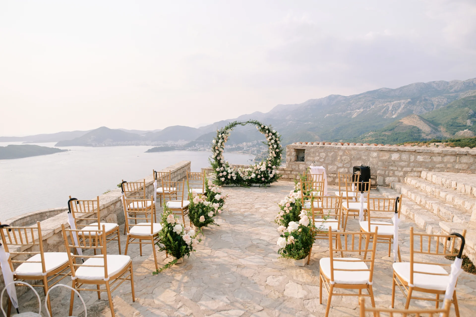 A wedding ceremony with chairs and flowers