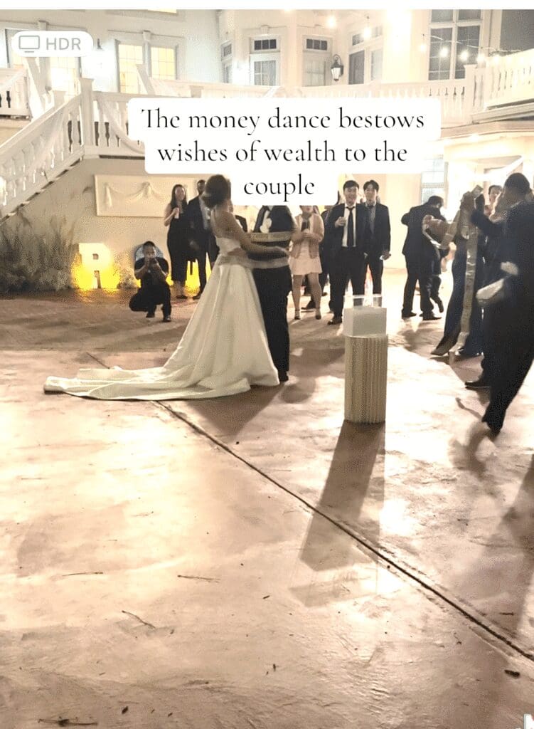 A bride and groom dance joyfully at their wedding reception.
