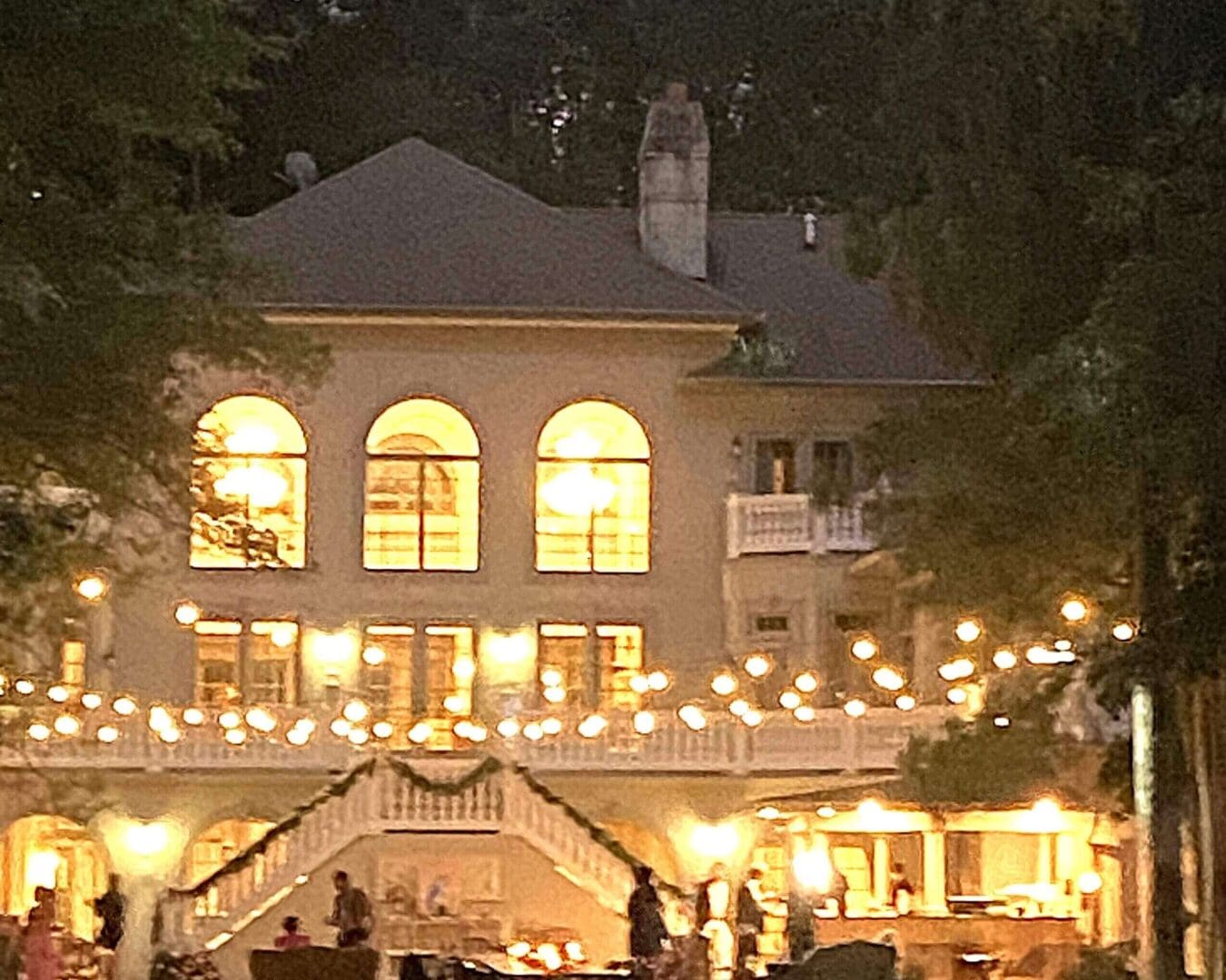 A warmly lit building with string lights